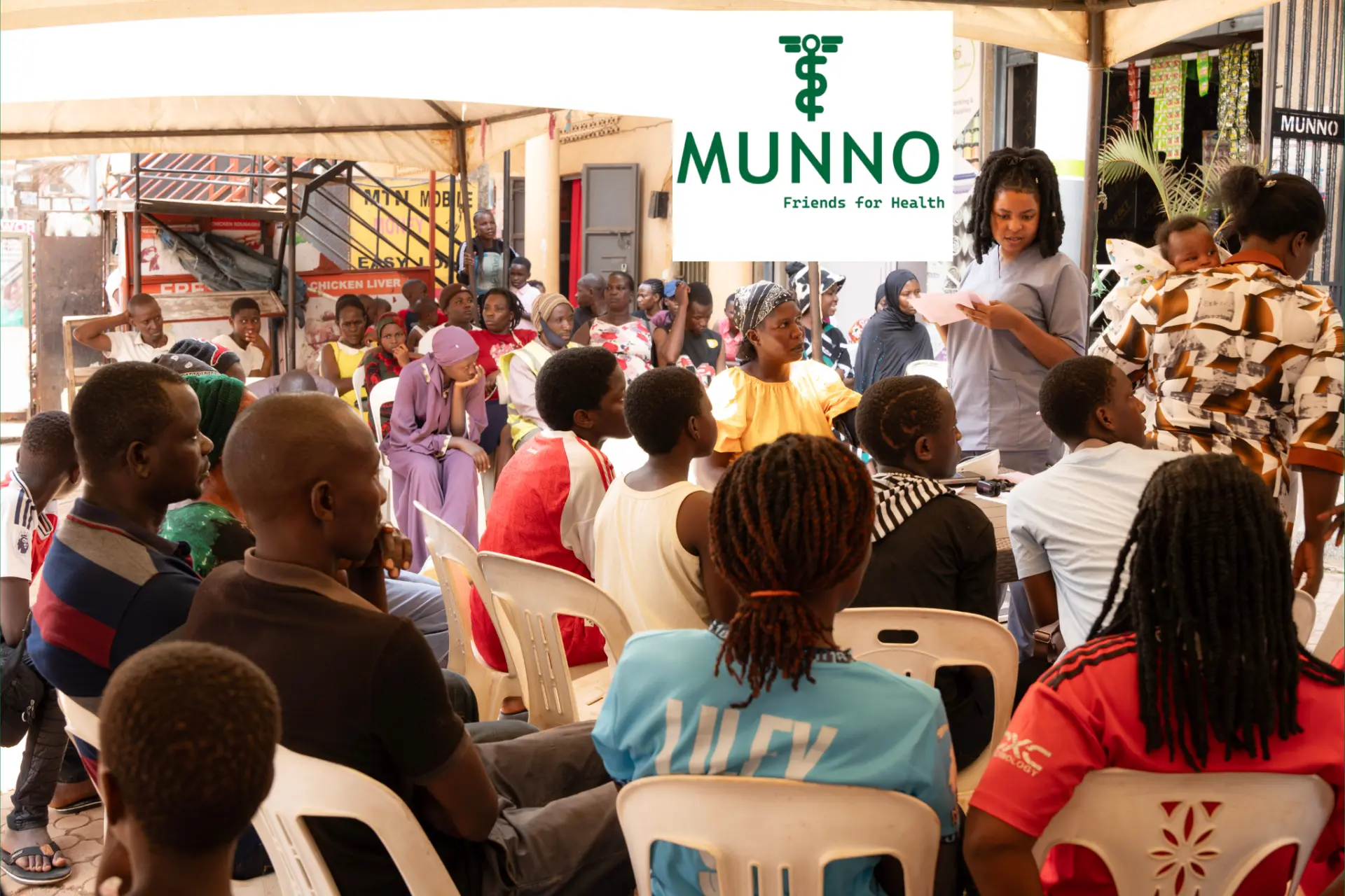 Munno Health team speaking with community members at an outdoor gathering